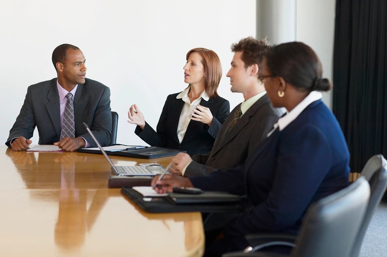 A group of people sitting at a table.