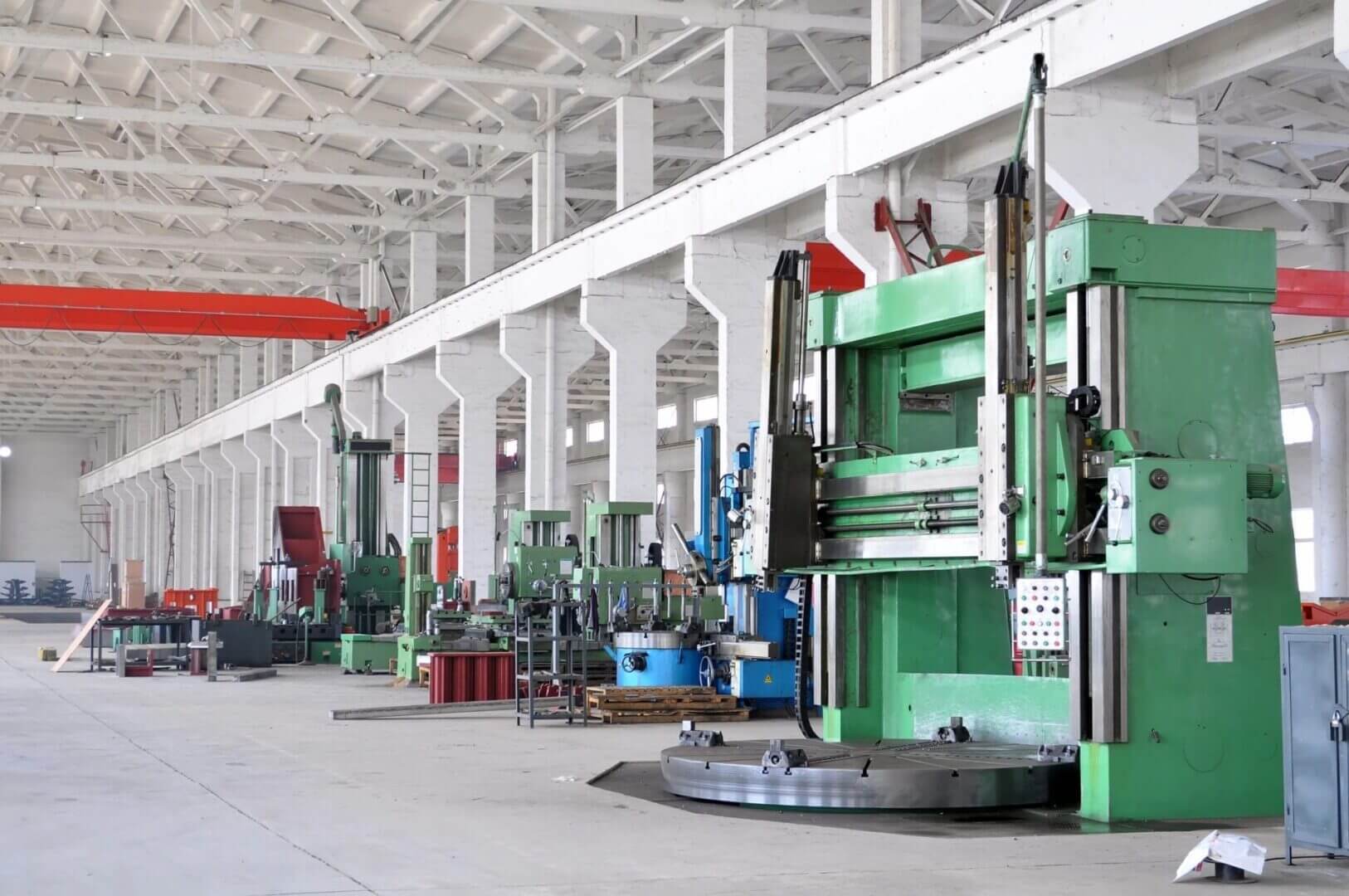 Industrial machines in a large factory interior.